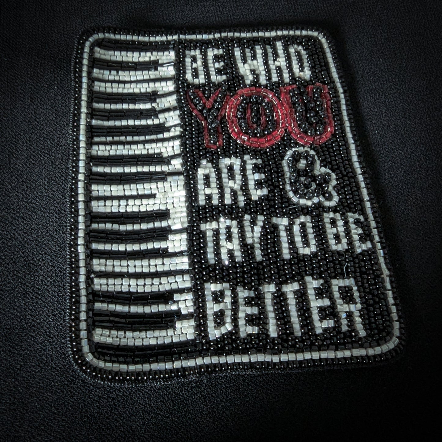Black and white beaded patch, 7x9cm, featuring a piano keyboard and "BE WHO YOU ARE & TRY TO BE BETTER" text.
