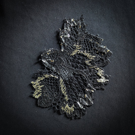 Black D&G lace flower patch with gold accents, 10x13 cm, on a dark fabric.