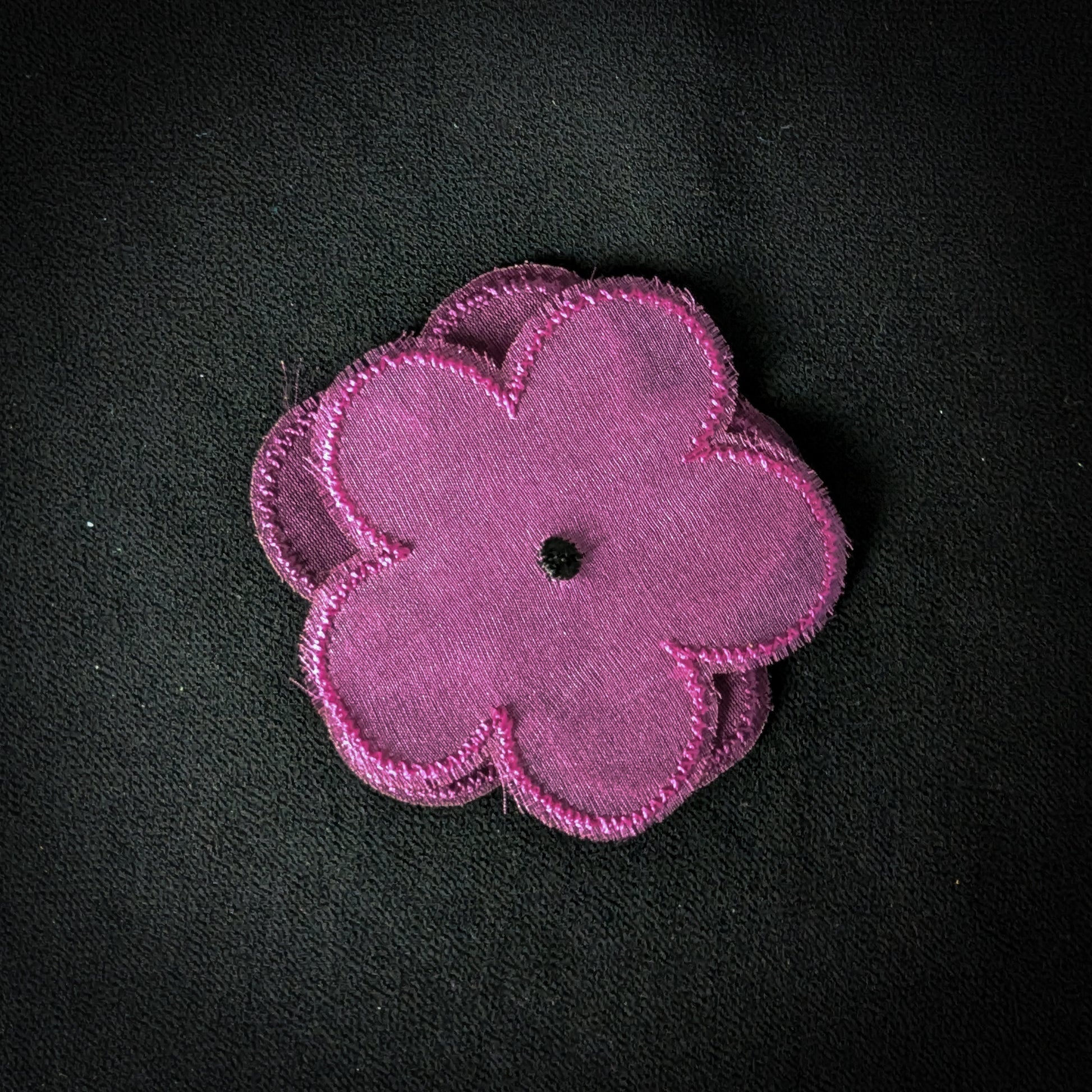 D&G embroidered tulle flower patch, 6x6cm, in vibrant magenta with a black center.
