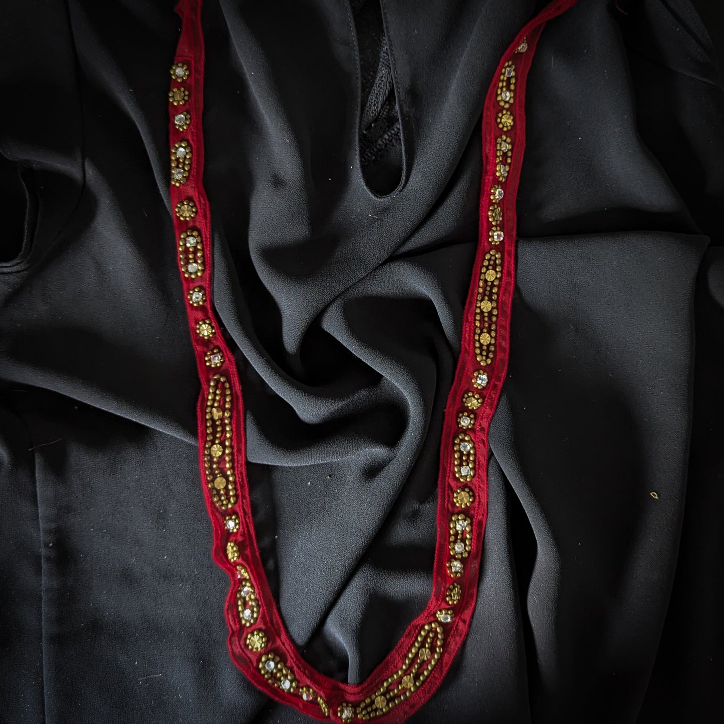 Red D&G decorative trim, 2x70cm, with gold beads and clear rhinestones on black fabric.