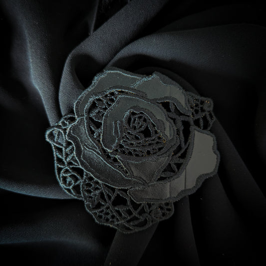 Black D&G rose patch with intricate lace and leather details, 8x9 cm, on dark fabric.