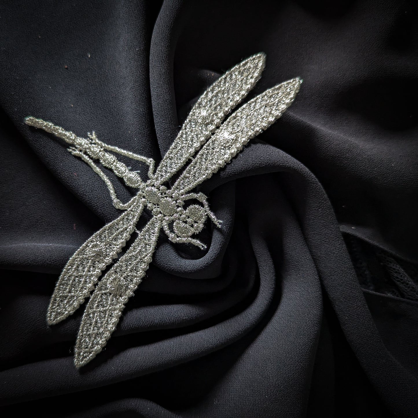 Silver D&G dragonfly patch, 9x15 cm, with intricate embroidery on a dark fabric background.