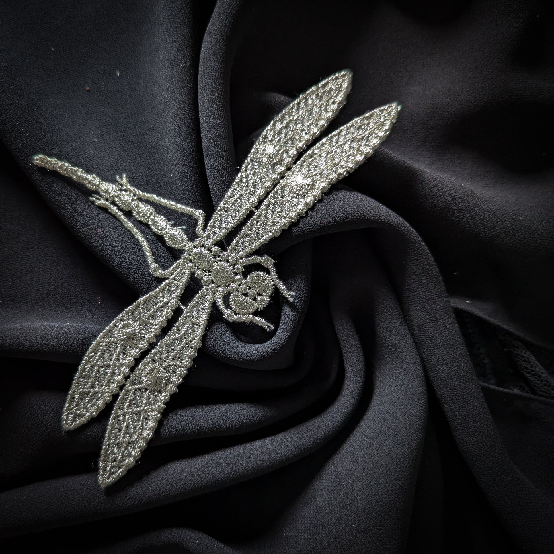 Silver D&G dragonfly patch, 9x15 cm, with intricate embroidery on a dark fabric background.