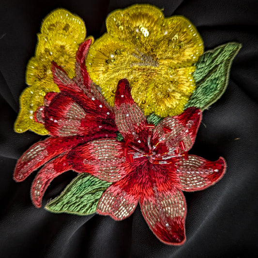 Embroidered floral patch with red beaded lily, yellow sequin flowers, and green leaves.