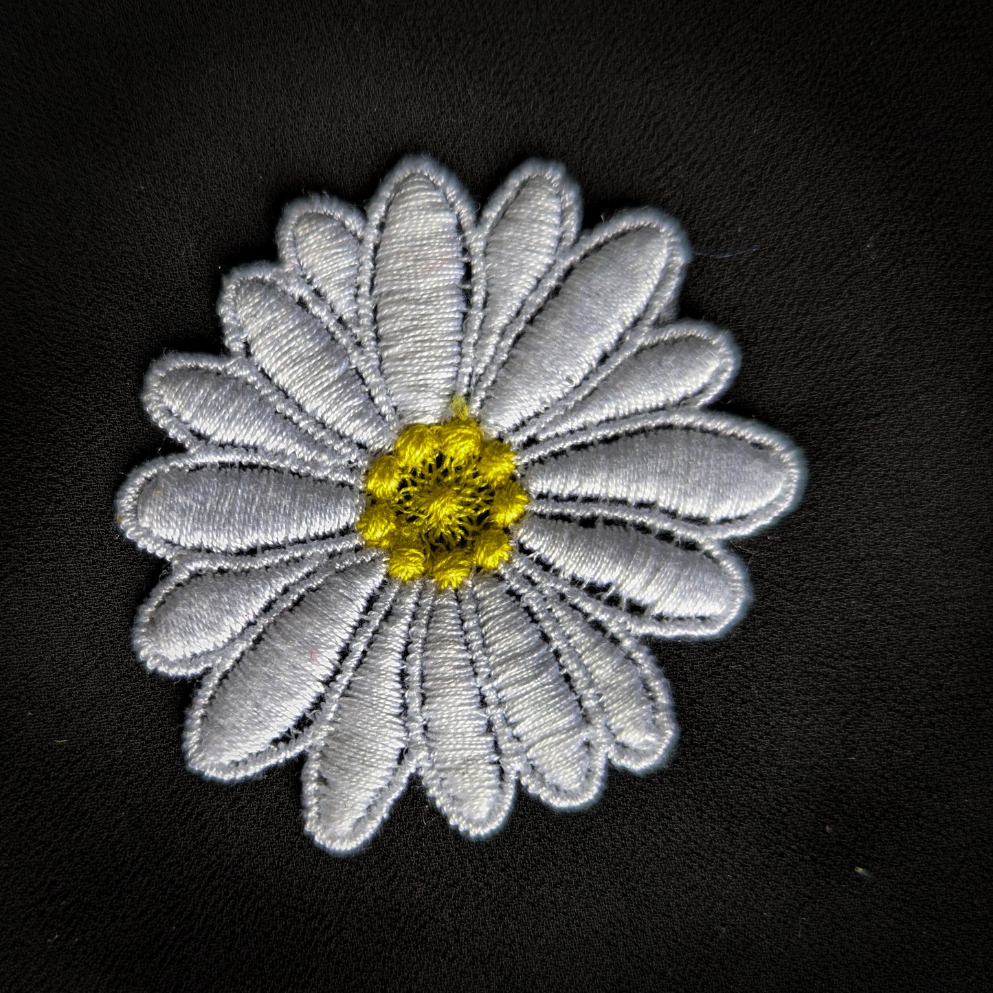 D&G large white daisy patch with yellow center, 10x11cm, embroidered on black fabric.