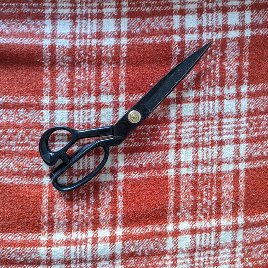 Pantone Red Clay and white plaid Alpaka-Tweed fabric with black tailoring scissors.