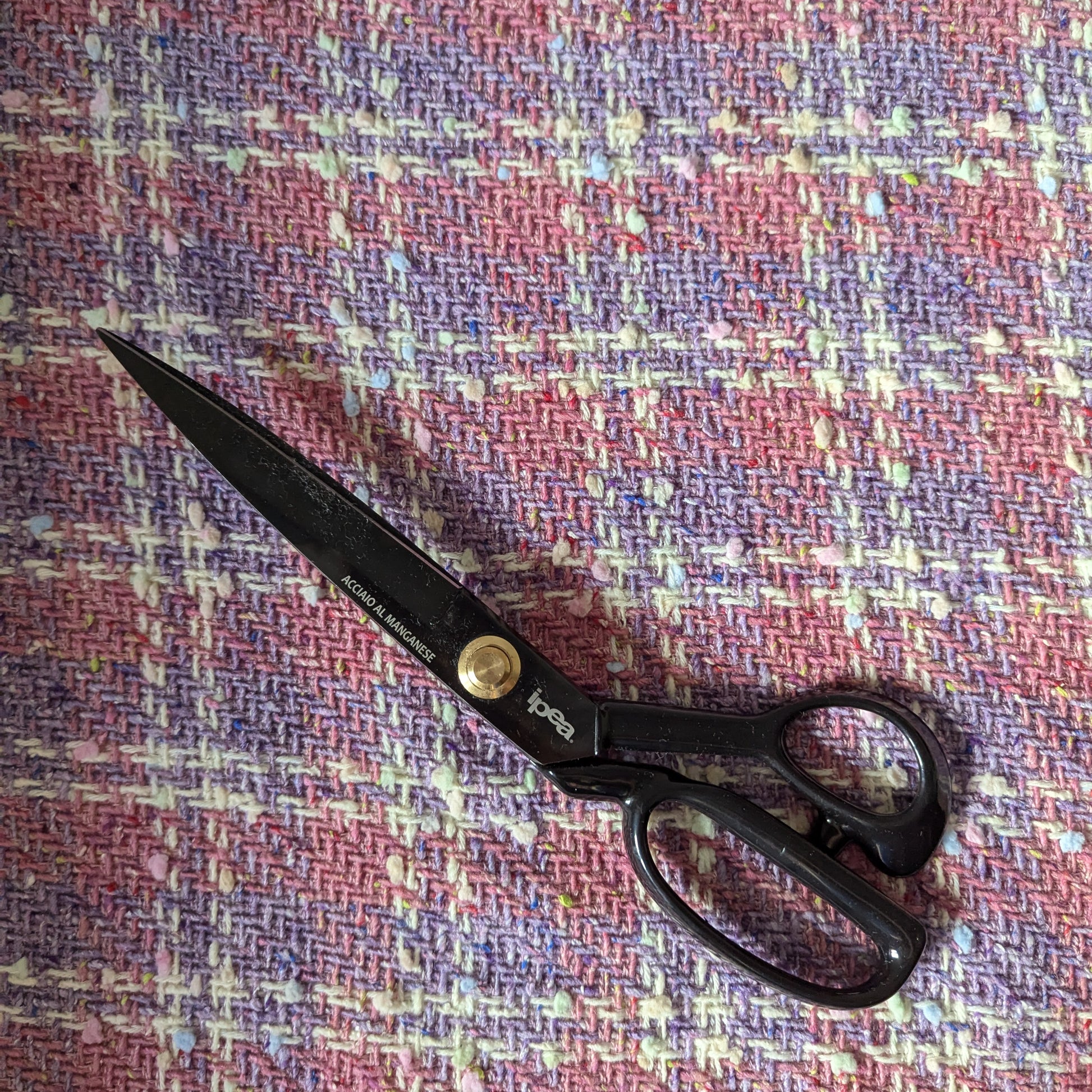 Deadstock G###i tweed fabric in Chateau Rose and Bougainvillea Blush Powder with black fabric shears.