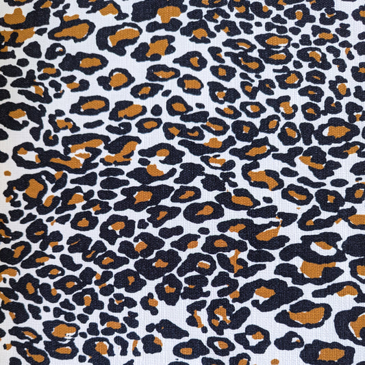Deadstock cotton fabric with a bold black and brown leopard print on a white background.