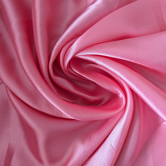 Swirling bubblegum pink Alexander McQueen deadstock viscose lining fabric, smooth and subtly shiny.