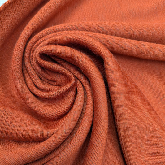 Orange double-face wool cashmere jersey fabric, 75x100cm, with soft folds.