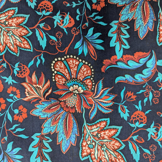 Deadstock parachute silk fabric in Sky Captain blue with vibrant red and turquoise floral pattern, water-repellent.