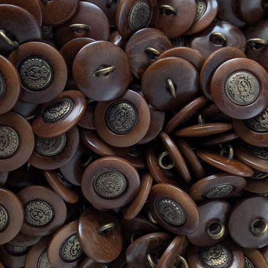 Dark brown Bongossi wood buttons with antique brass-colored metal crests, 2cm, for sewing.