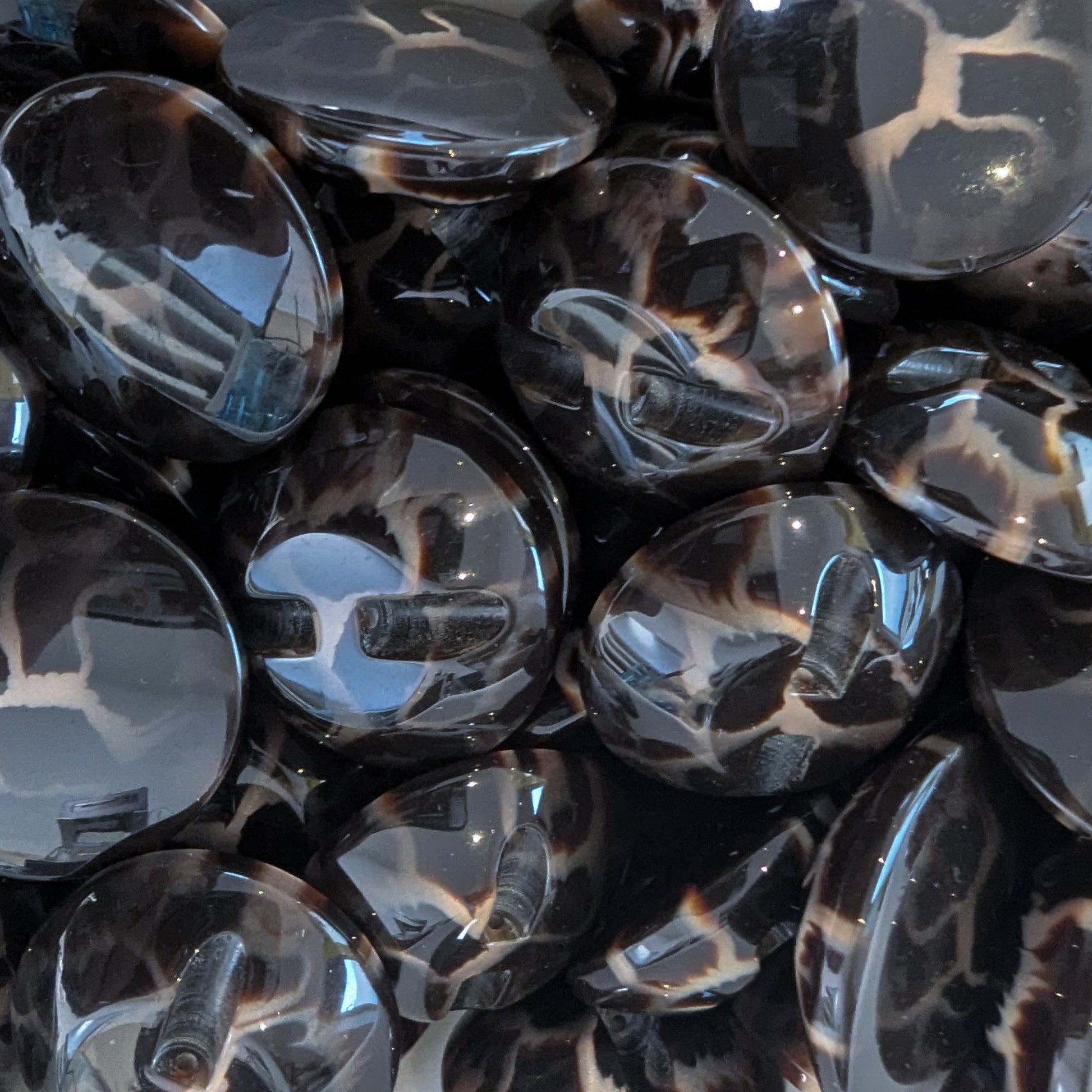 Glossy dark brown plastic buttons with black and beige leopard print, approximately 3 cm.