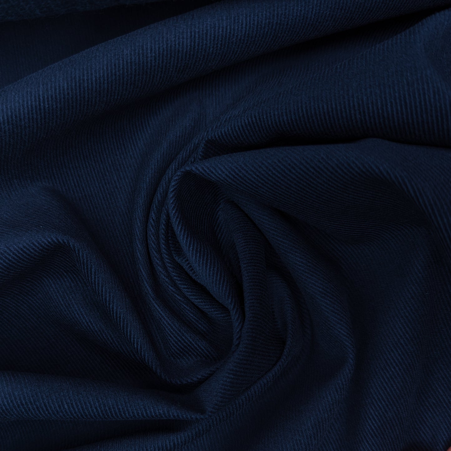 Dark blue Feincord deadstock fabric, 110 cm wide, with fine corduroy texture and elegant folds.