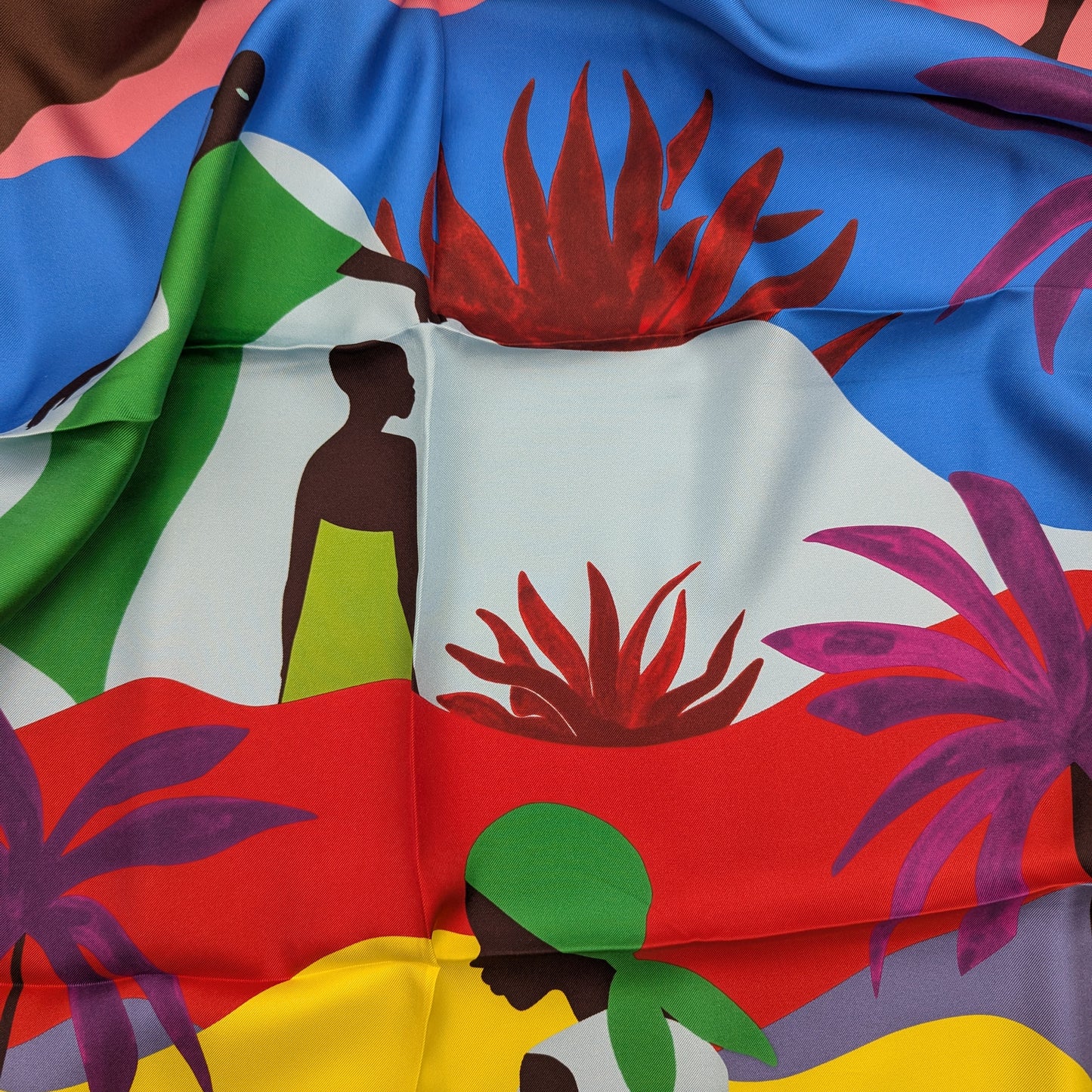 Ungaro 90x90cm silk scarf with vibrant tropical print, featuring figures, palm trees, and abstract shapes.