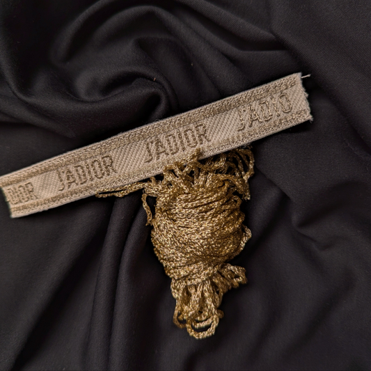 Gold J'ADIOR silk-lurex DIY bracelet band, 14x2 cm, with matching coiled thread on dark fabric.