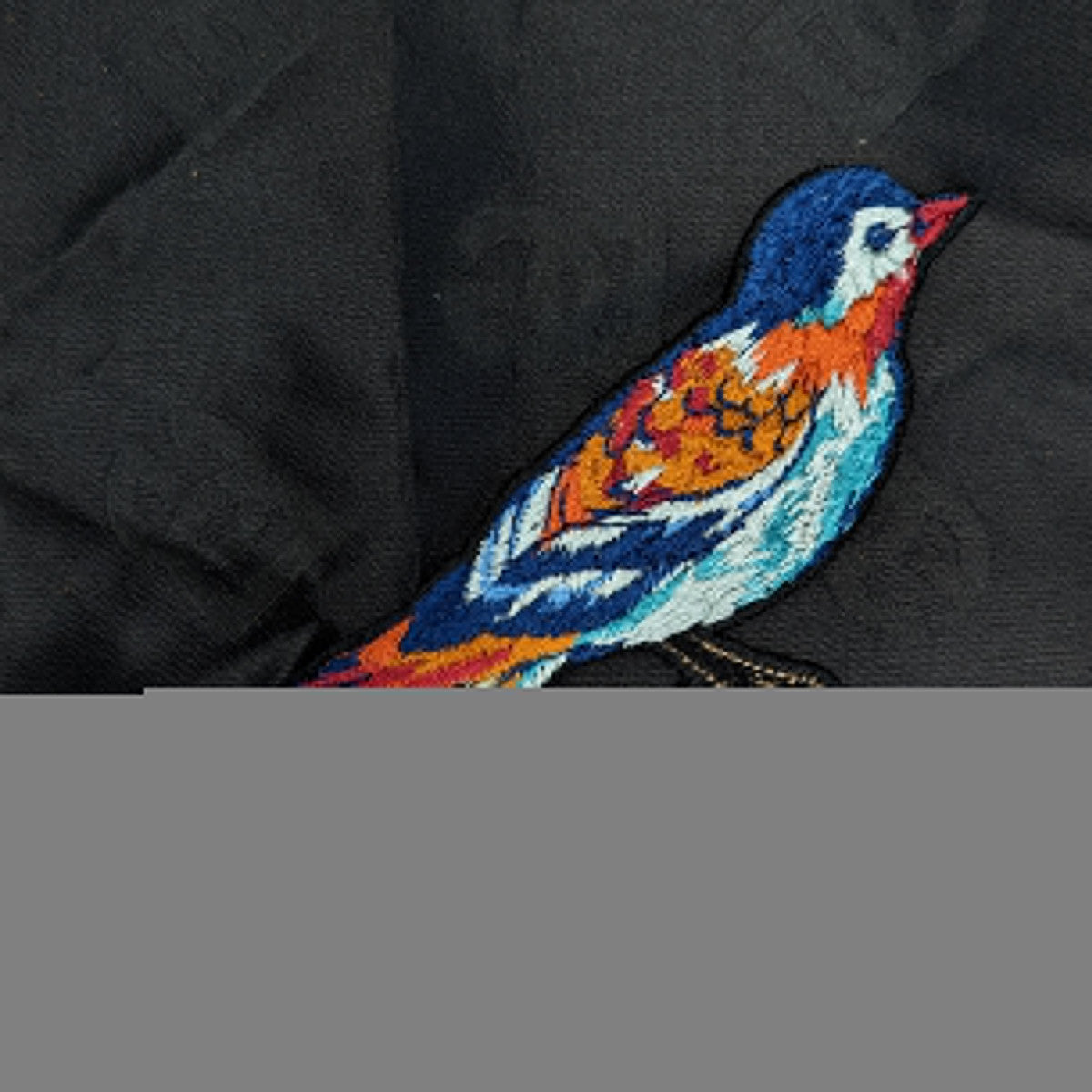 Colorful embroidered bird patch, 16x6cm, with blue, orange, and white threads on black fabric.