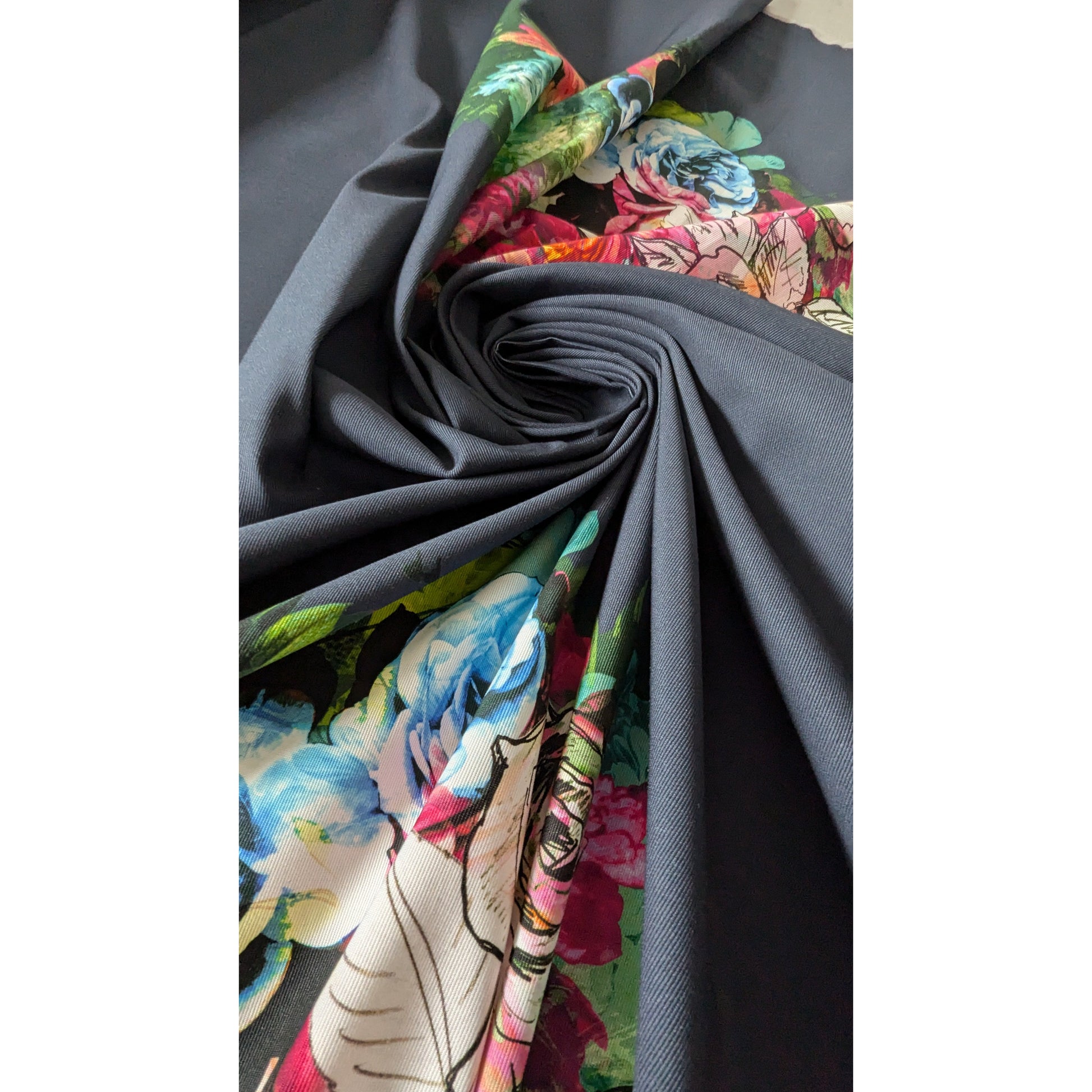 Mehrfarbig floral deadstock denim fabric panel, 150cm wide, with a dark gray base and vibrant flowers.