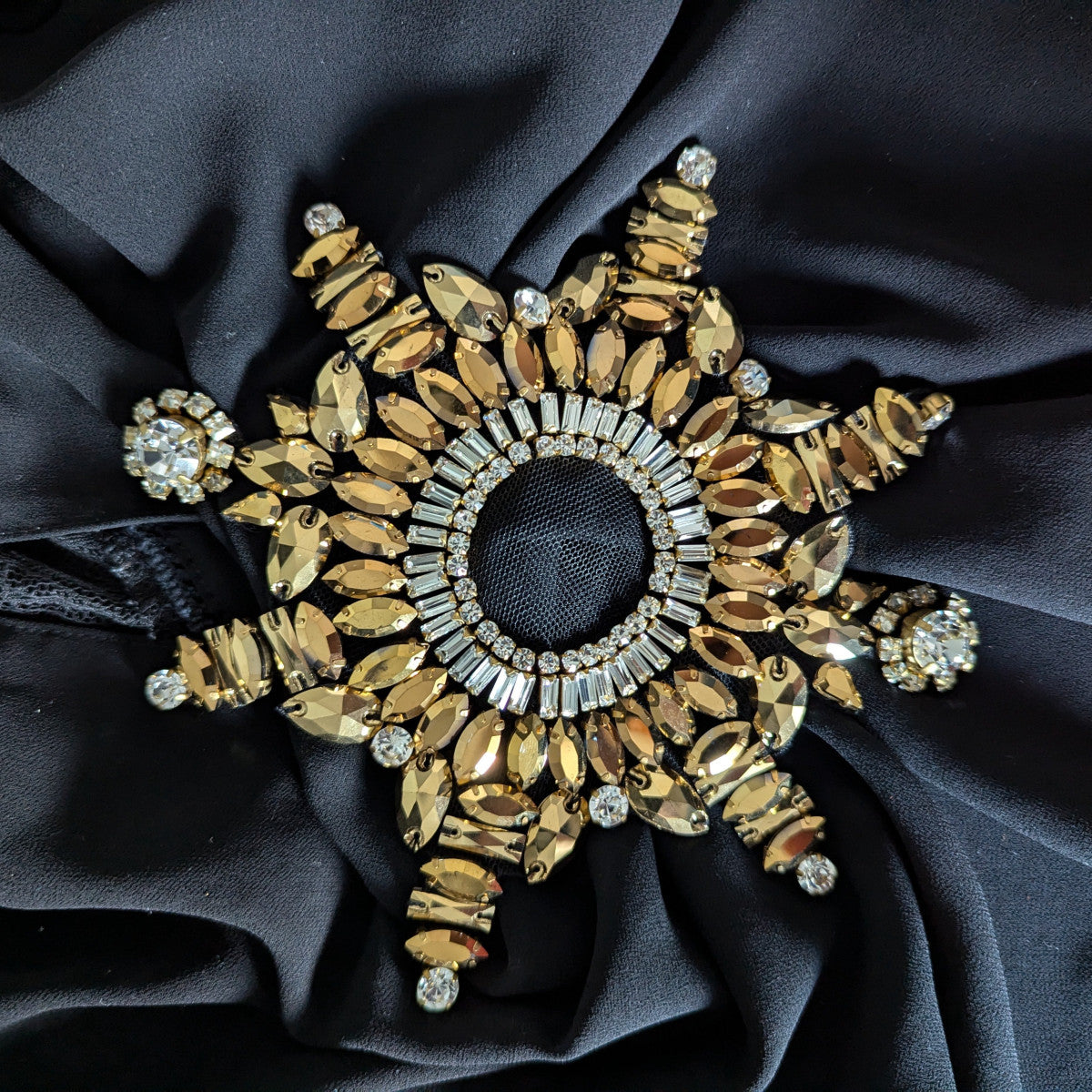 D&G star patch with gold Swarovskis, clear stones, and pearls on black fabric.