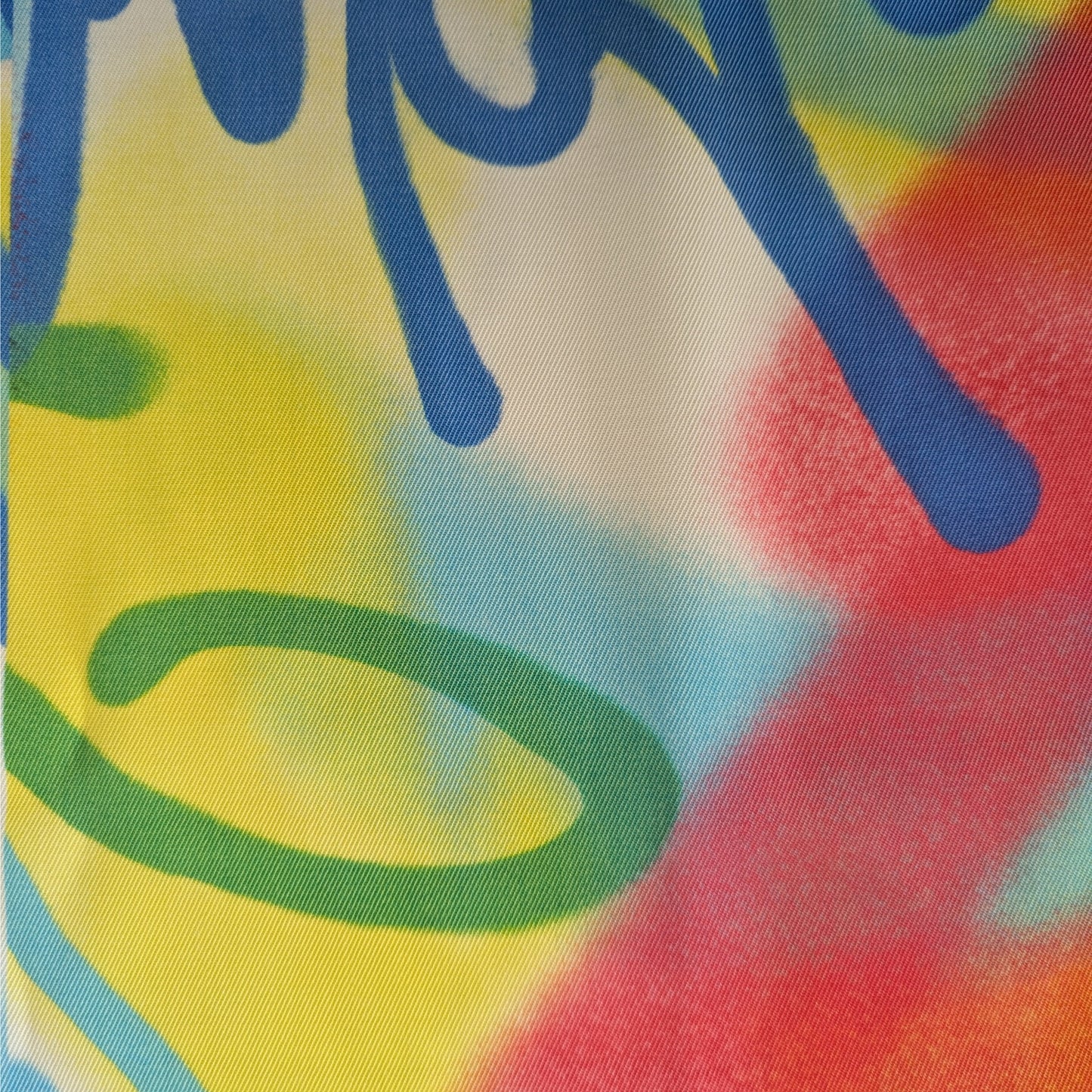 D&G deadstock wool twill fabric panel with colorful graffiti print in blue, yellow, red, and green.