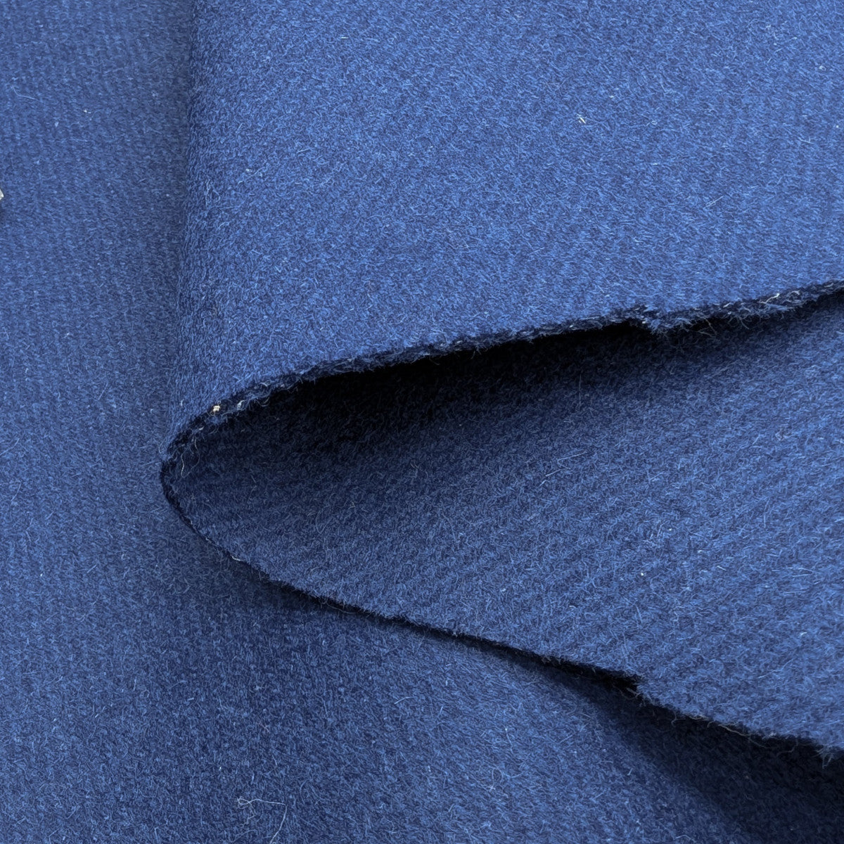 Dark blue wool-rabbit doubleface deadstock fabric, 150cm, with a visible raw edge.