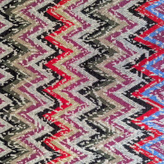 Thick doubleface knit fabric with a colorful zigzag pattern in red, blue, purple, black, and beige.
