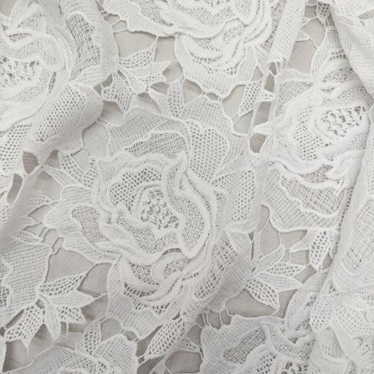 White deadstock cotton lace fabric with intricate 3D rose patterns, heavy quality.