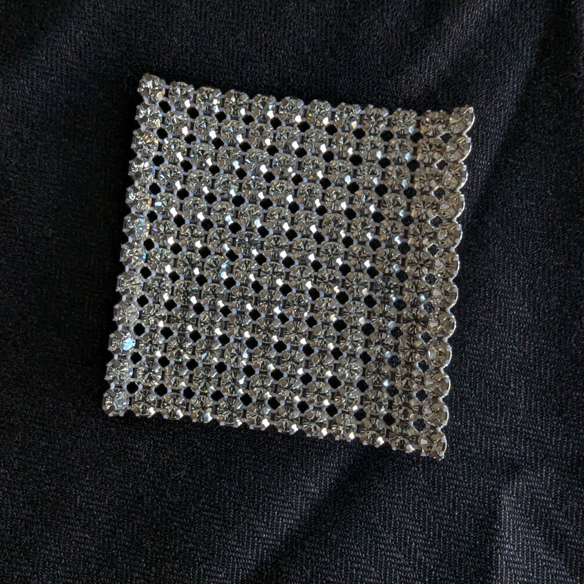 Square D&G Swarovski & Kristall patch with clear rhinestones on black fabric.