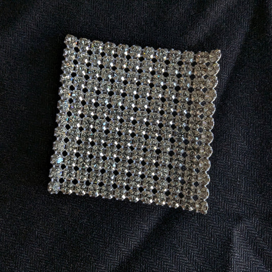 Square D&G Swarovski & Kristall patch with clear rhinestones on black fabric.
