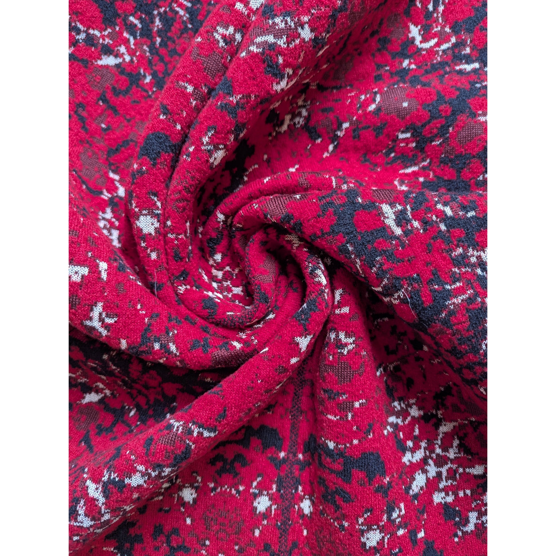 Red Missoni deadstock wool knit fabric with black and white abstract pattern, swirled.