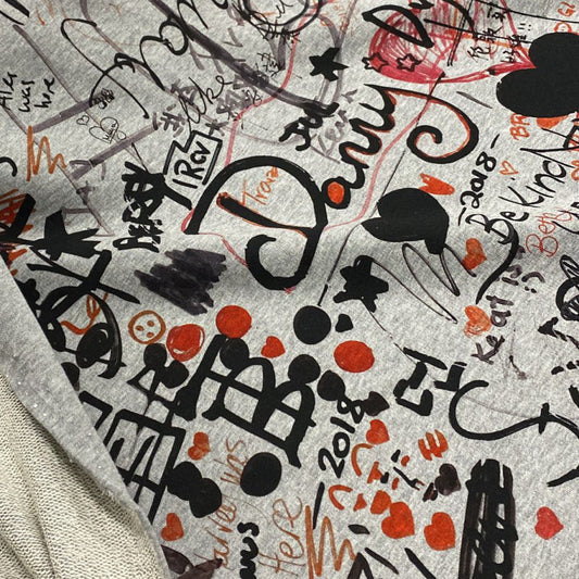 Light gray deadstock B*rberry sweat panel fabric with black, red, and orange graffiti-style doodles.