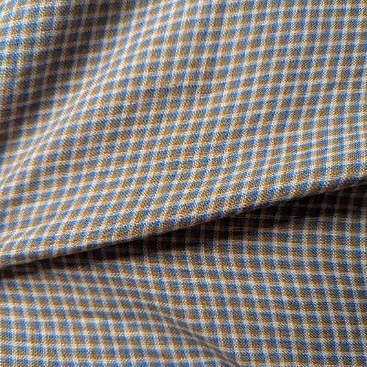 Deadstock linen-cotton blend fabric with blue, tan, and cream checkered pattern, natural texture.