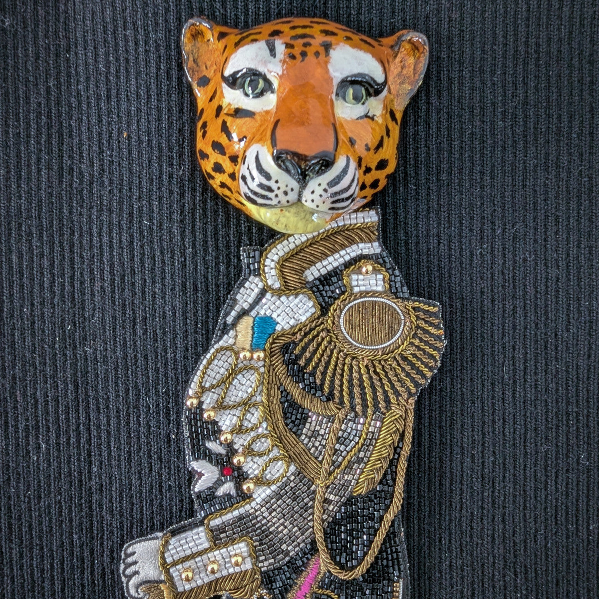 D&G embroidered leopard head patch in uniform, 30cm, with gold, silver, and black details.