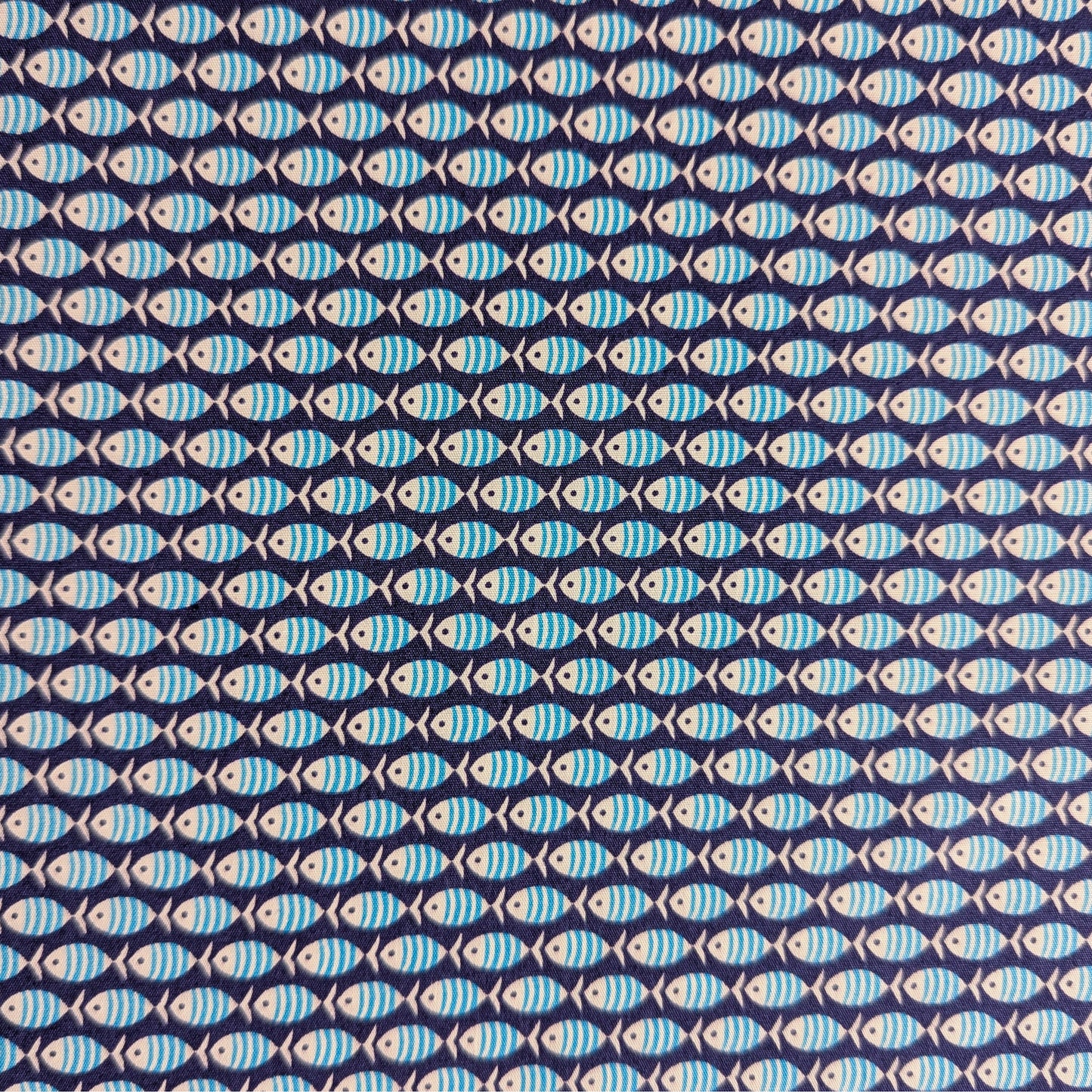 Dark blue cotton poplin fabric with a repeating pattern of light blue striped fish.