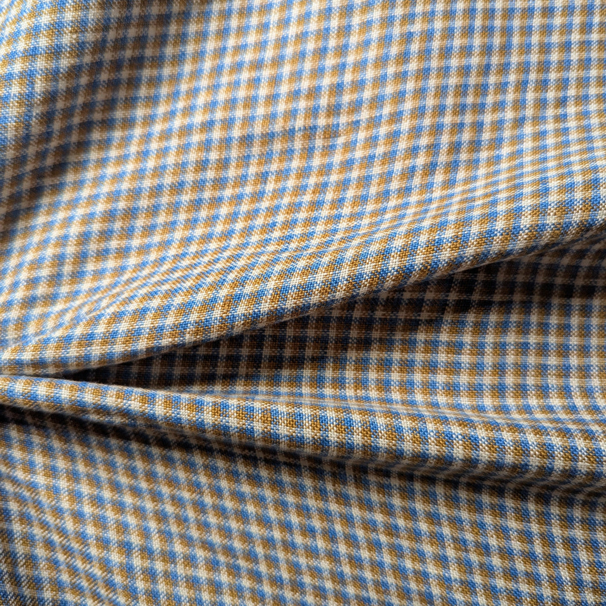 Blue and natural tan checkered linen-cotton blend fabric with a visible natural texture.