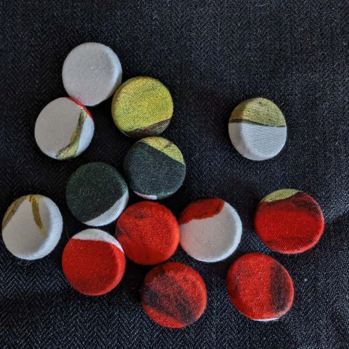 Assorted 1.3cm silk-covered buttons in red, green, yellow, and white patterns on black fabric.