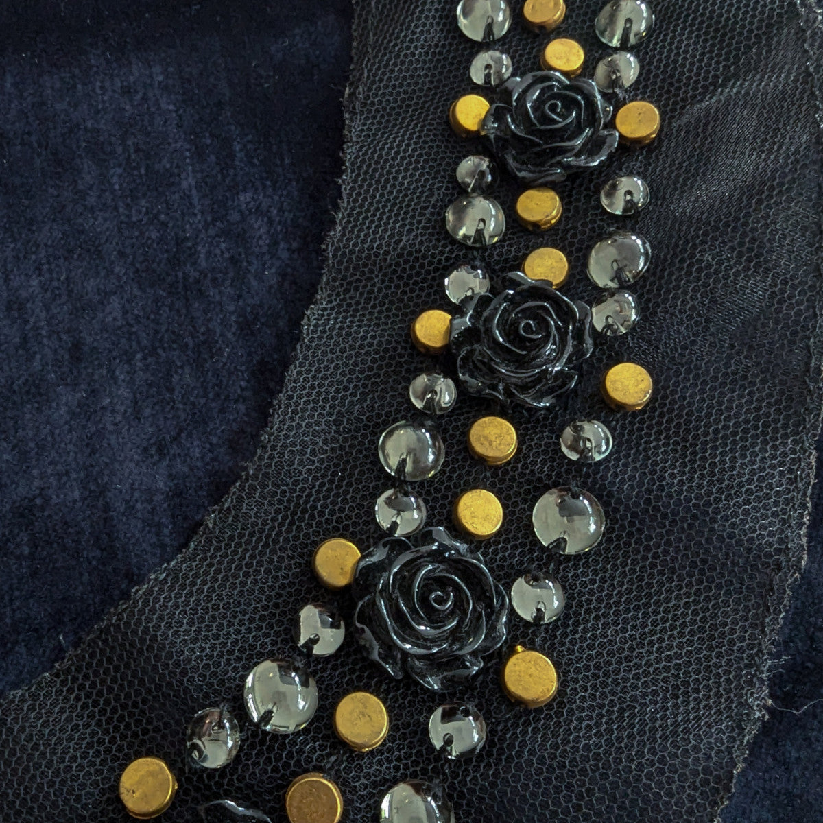 D&G black mesh patch with gold studs, clear beads, and black rose appliques.