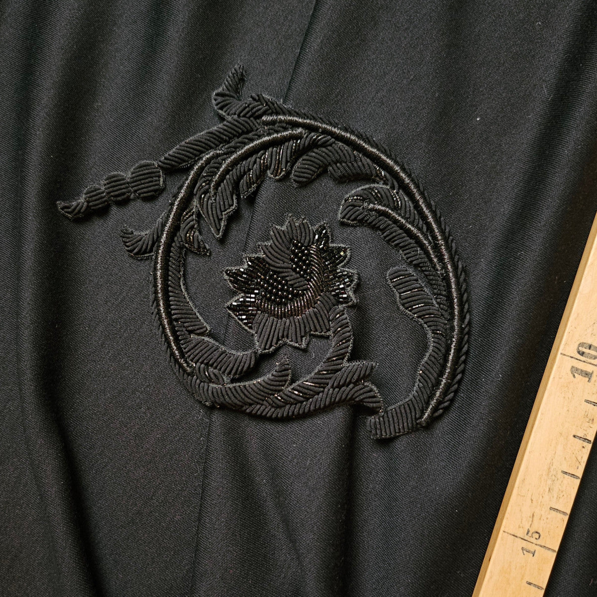 Black D&G patch with intricate metal embroidery in an ornate floral design, 11cm.