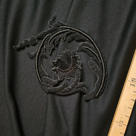 Black D&G patch with intricate metal embroidery in an ornate floral design, 11cm.