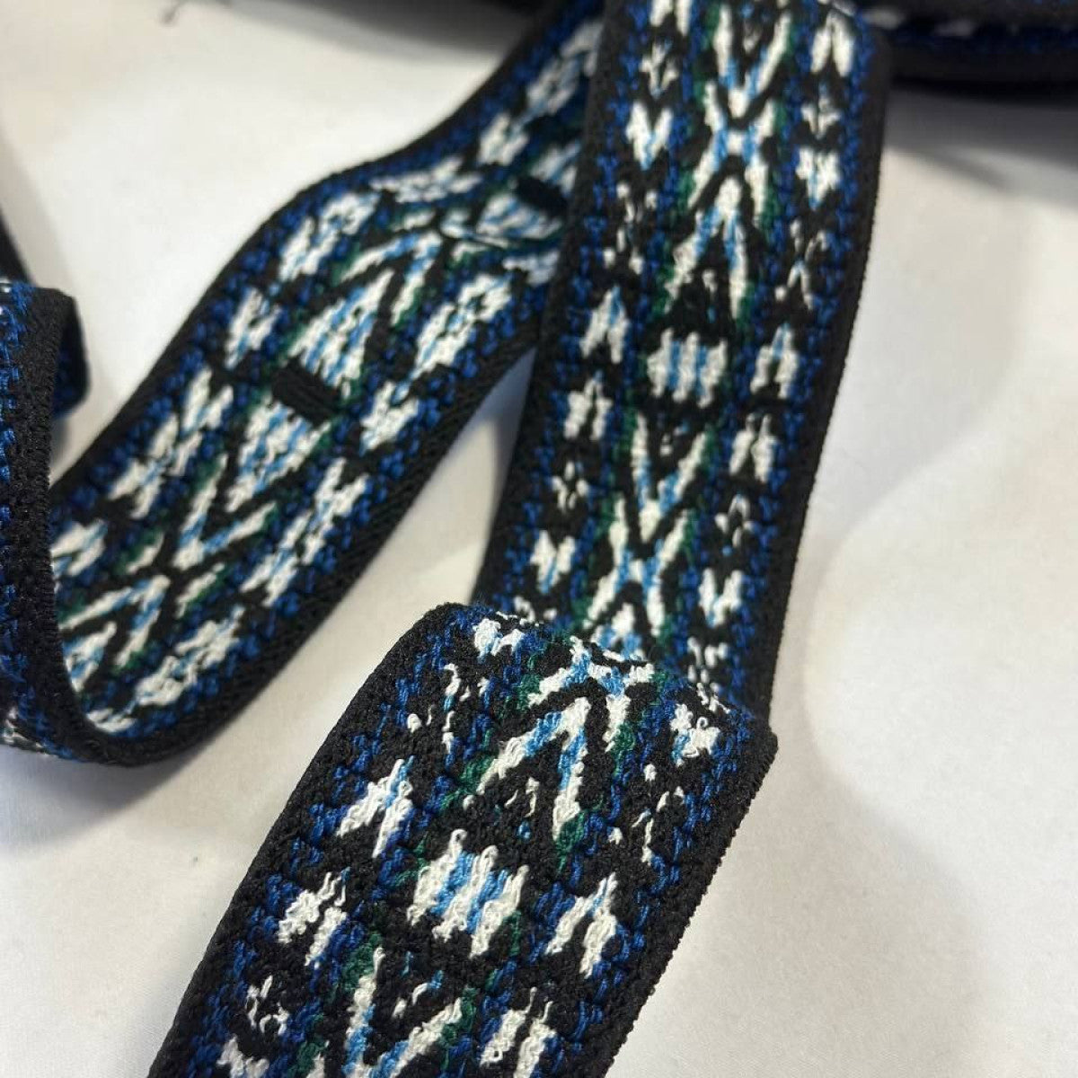 Black designer fabric band with blue, green, and white geometric pattern.