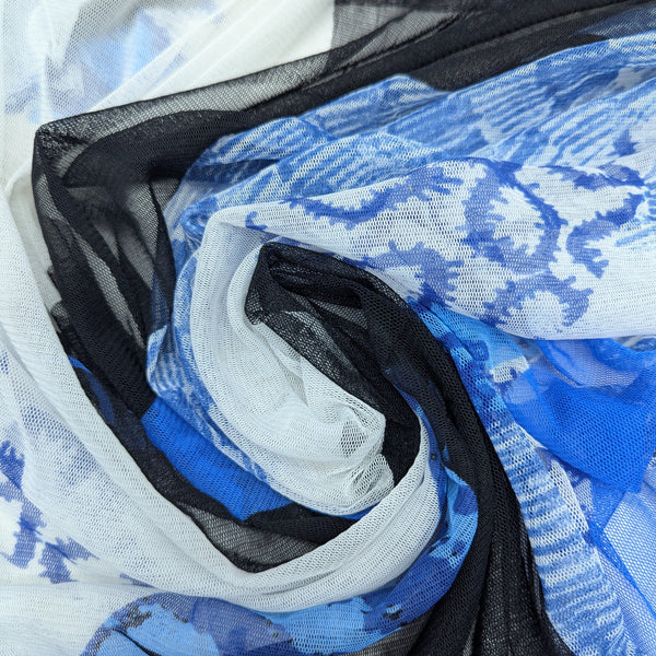Deadstock Feintüll fabric, 185 cm wide, with abstract blue and white print and black mesh overlay.