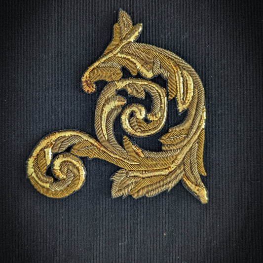D&G gold metallic embroidery patch, 15cm, with ornate swirling leaf design on black fabric.