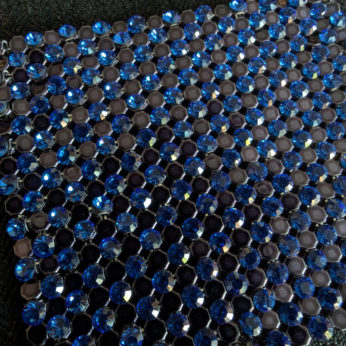 D&G Swarovski & Kristall patch with alternating rows of sparkling blue crystals and dark gray hexagons.