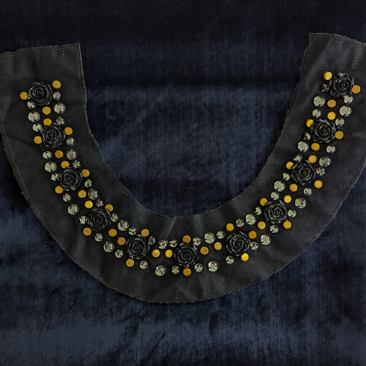 Black D&G pearl patch with yellow beads, black rose accents, and clear rhinestones on a dark background.