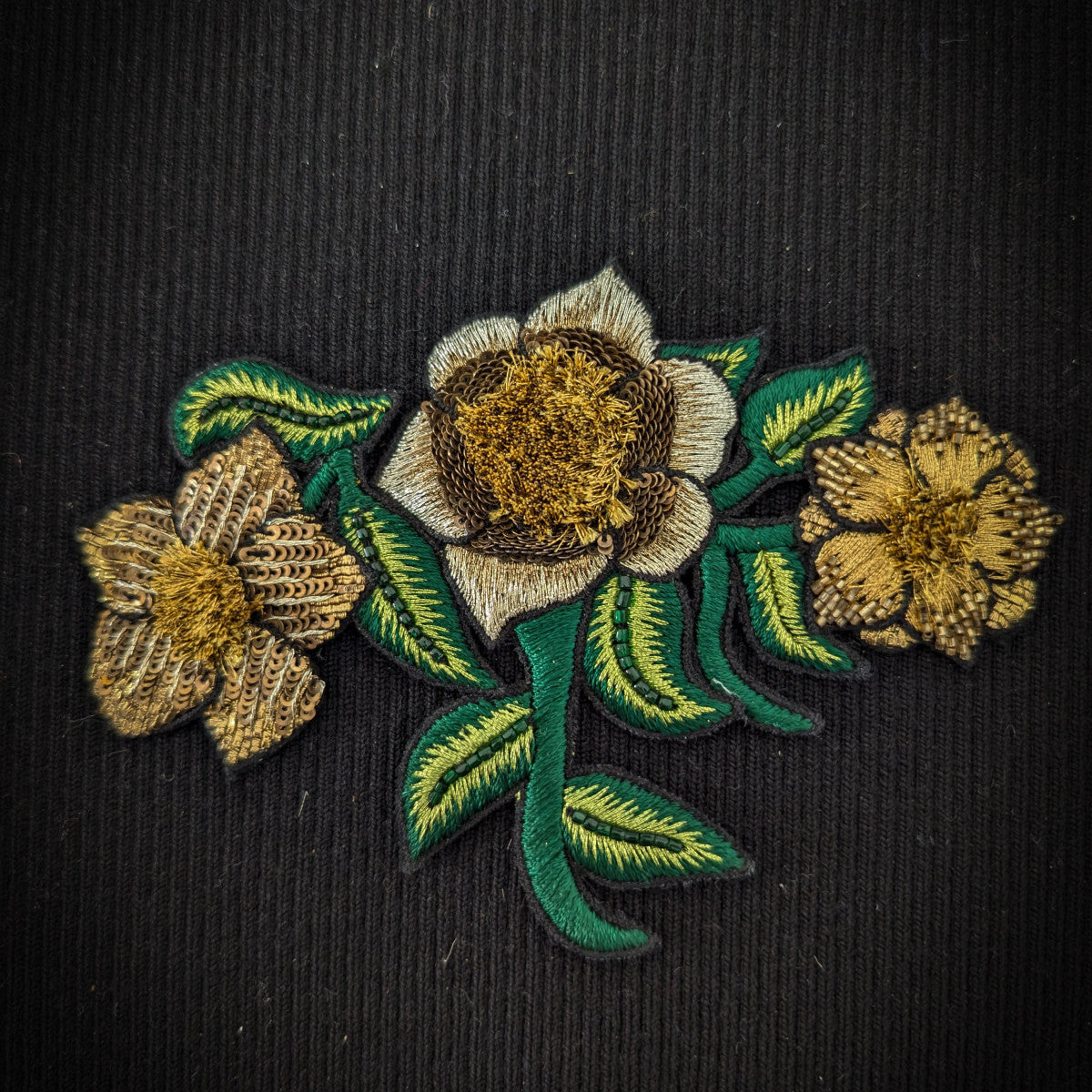 D&G 13cm 3D embroidered floral patch with gold, white, and green flowers and leaves on black fabric.