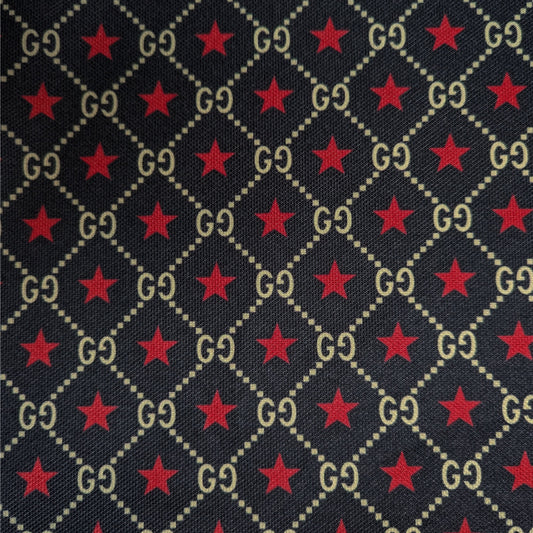 Dark blue Punto Milano jersey with repeating gold "GG" logo and red star pattern.