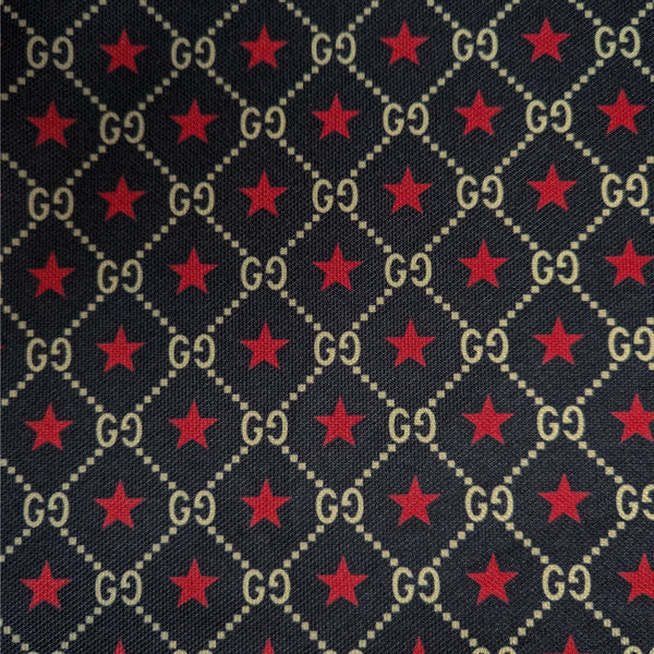 Dark blue Punto Milano jersey with repeating gold "GG" logo and red star pattern.