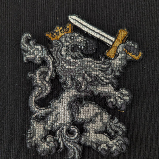 D&G cross-stitched lion patch with gold crown and sword, 15cm, on black fabric.