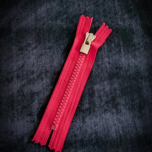 Neon pink YKK zipper with silver metal teeth and logo slider, 11 cm, designer deadstock.