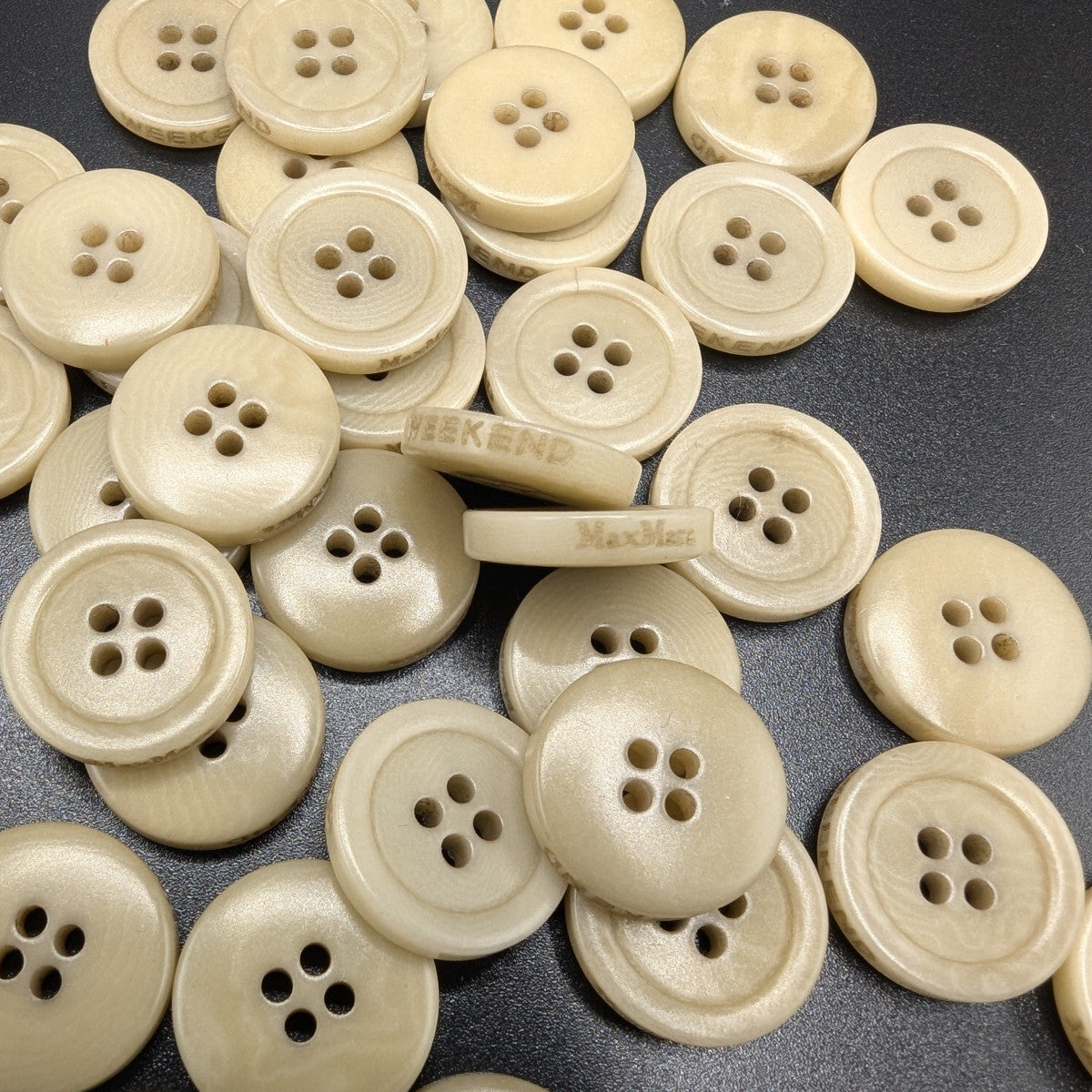 Creamy beige Max Mara 1.4cm four-hole buttons, some engraved with "WEEKEND" or "MaxMara".